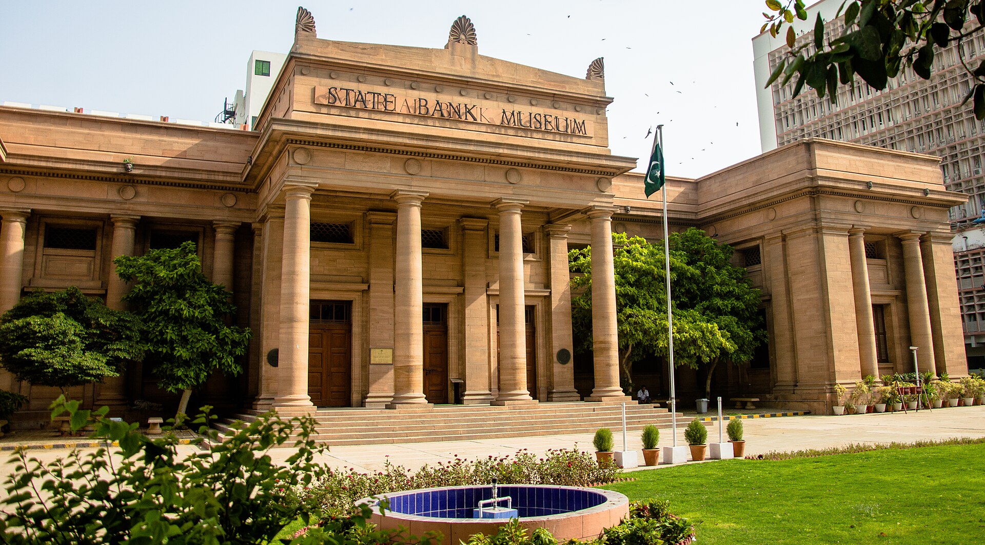 Colonnaded stone facade of the old State Bank of Pakistan building in Karachi